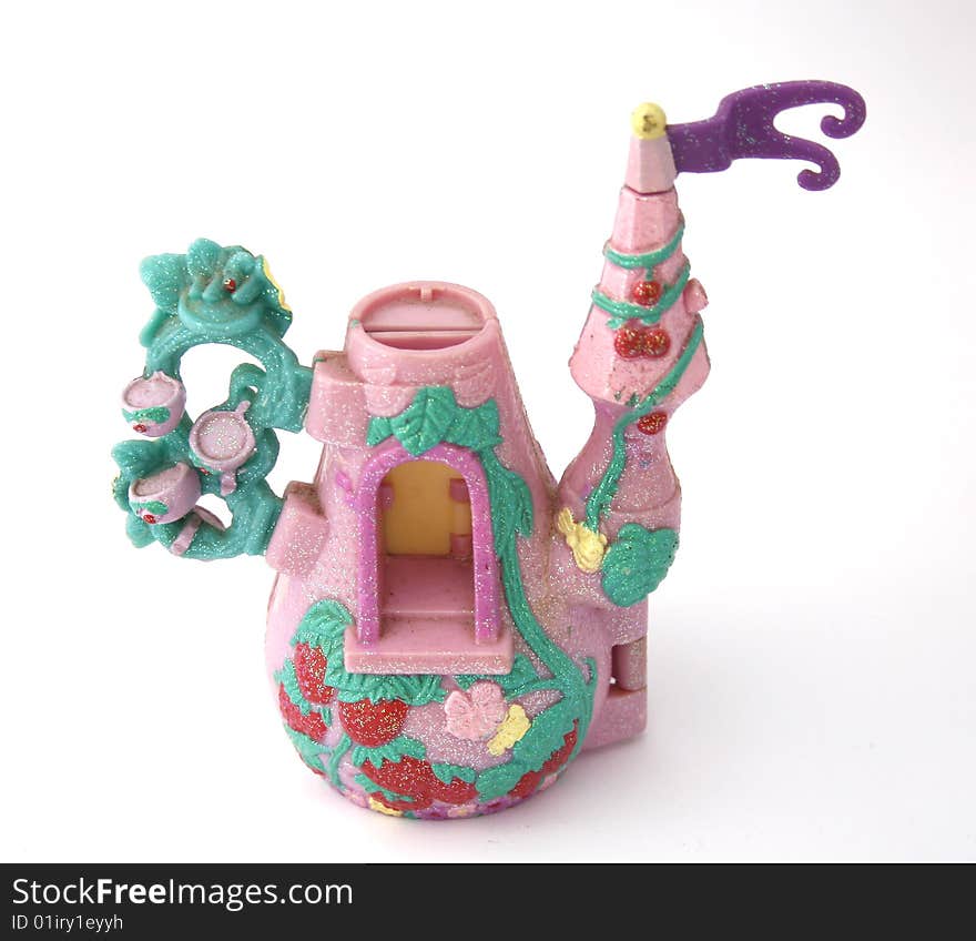 A child's pink toy tea pot play house isolated on a white background. A child's pink toy tea pot play house isolated on a white background