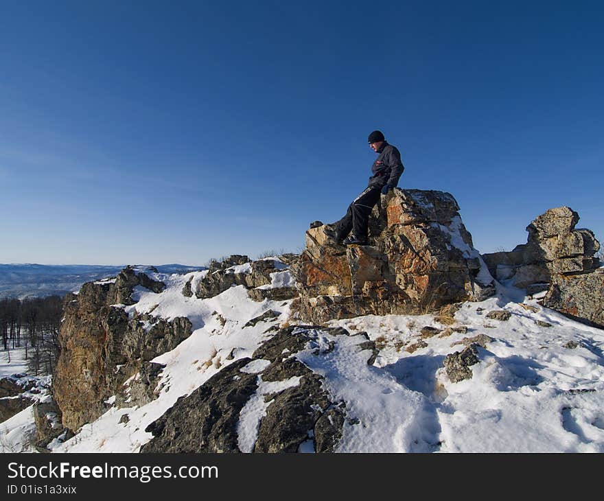 Single person high in the mountains clear winter day