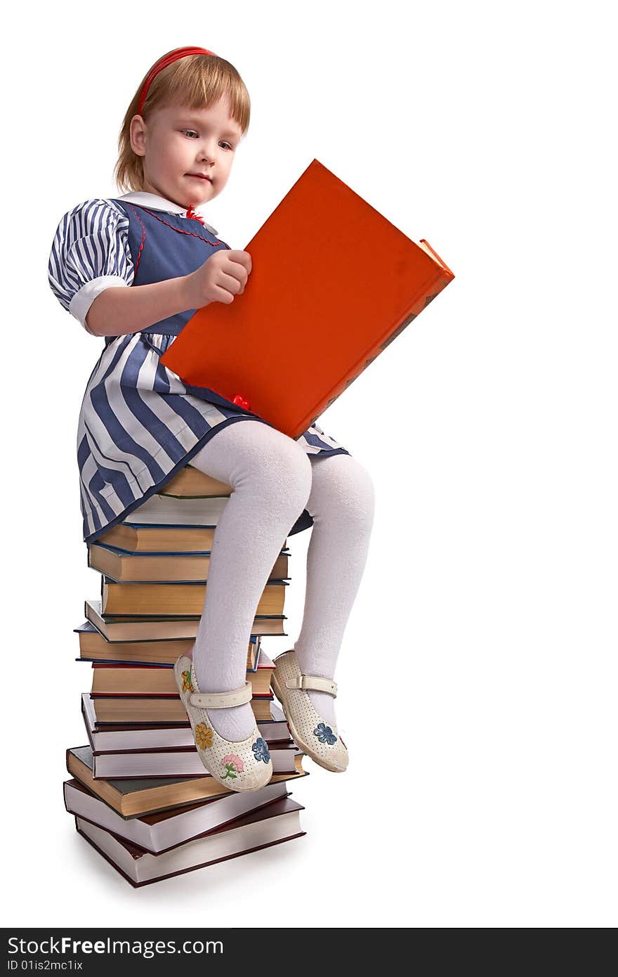 Schoolgirl sitting on the heap of books