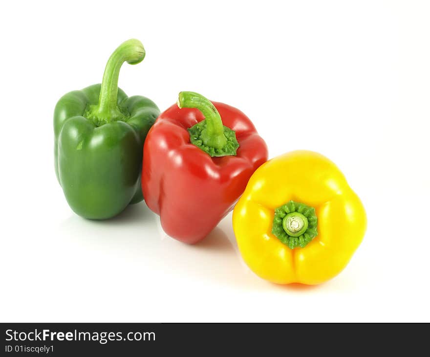 Red, green and yellow bell peppers on white isolated background. Red, green and yellow bell peppers on white isolated background.