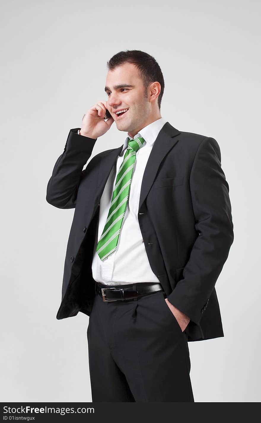 Portrait of a young smiling business man using cell phone. Portrait of a young smiling business man using cell phone