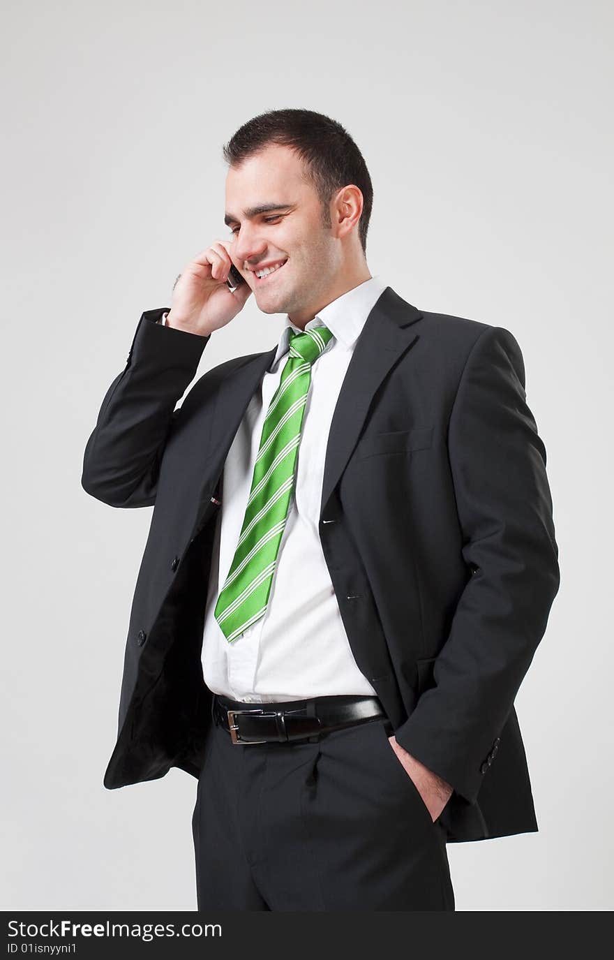 Portrait of a young smiling business man using cell phone. Portrait of a young smiling business man using cell phone