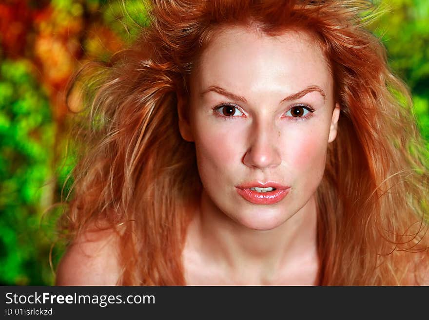 Portrait of the beautiful red-haired girl looking in an objective. Portrait of the beautiful red-haired girl looking in an objective