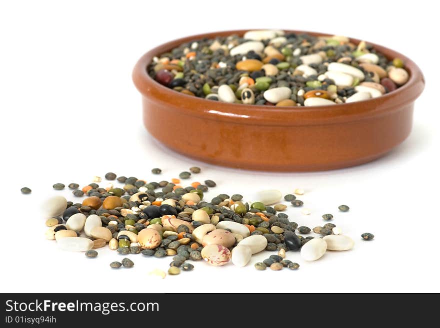 Assorted raw legumes in a cup, isolated