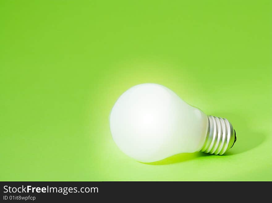 Light bulb on green background