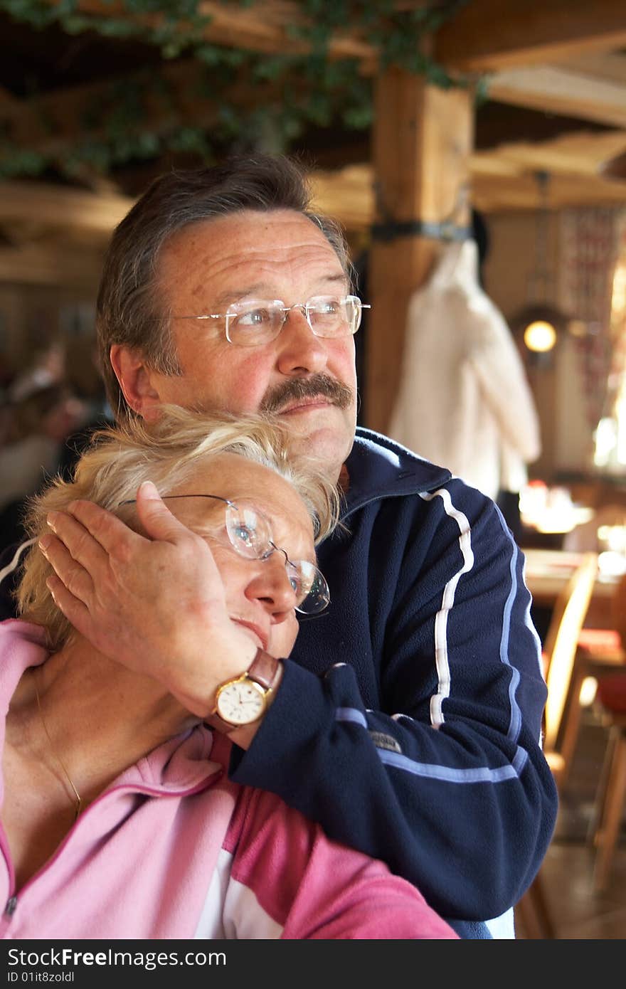 A senior couple is kissing and cuddling. A senior couple is kissing and cuddling.