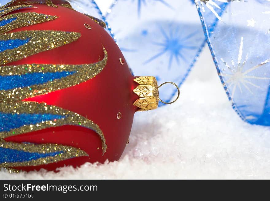 Red Christmas ball on snow background