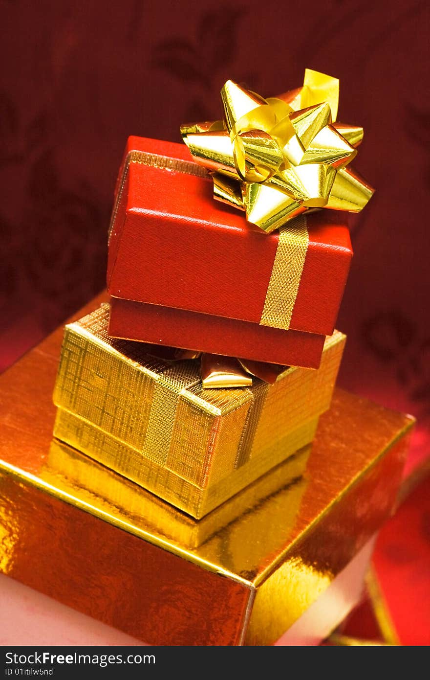 Red and golden gift boxes with bow