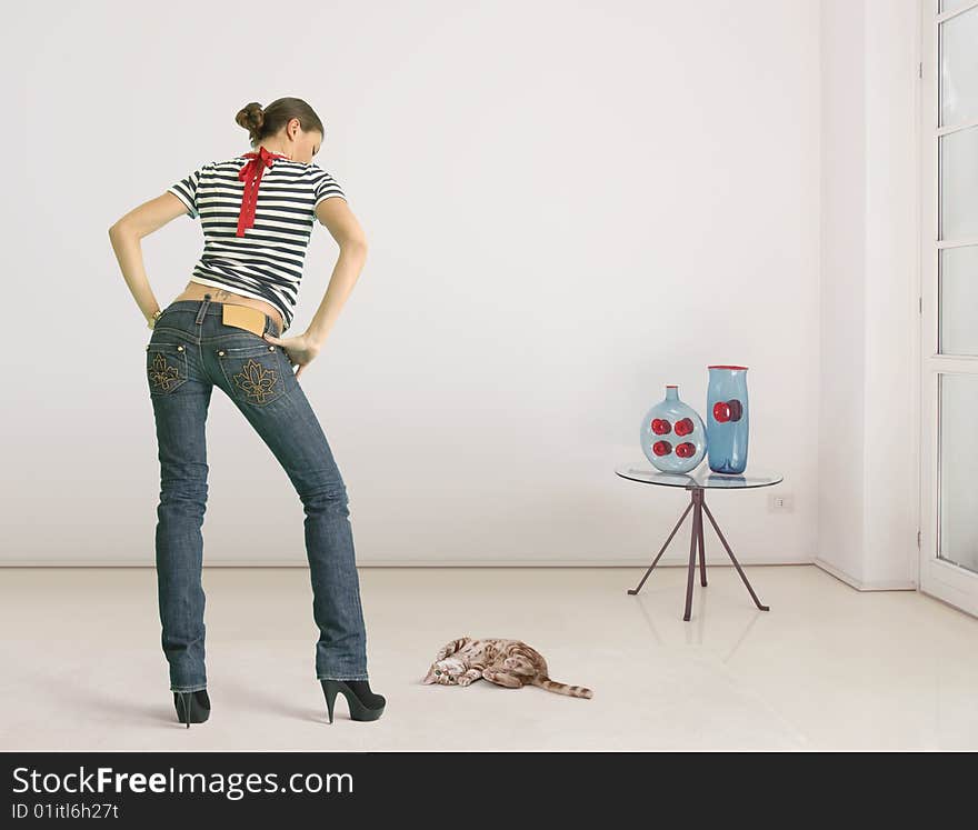 Young woman and cat in the room