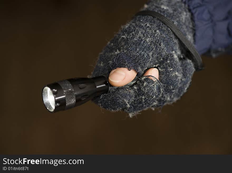 A hand with a lighting electric ttorch  is in night. A hand with a lighting electric ttorch  is in night.