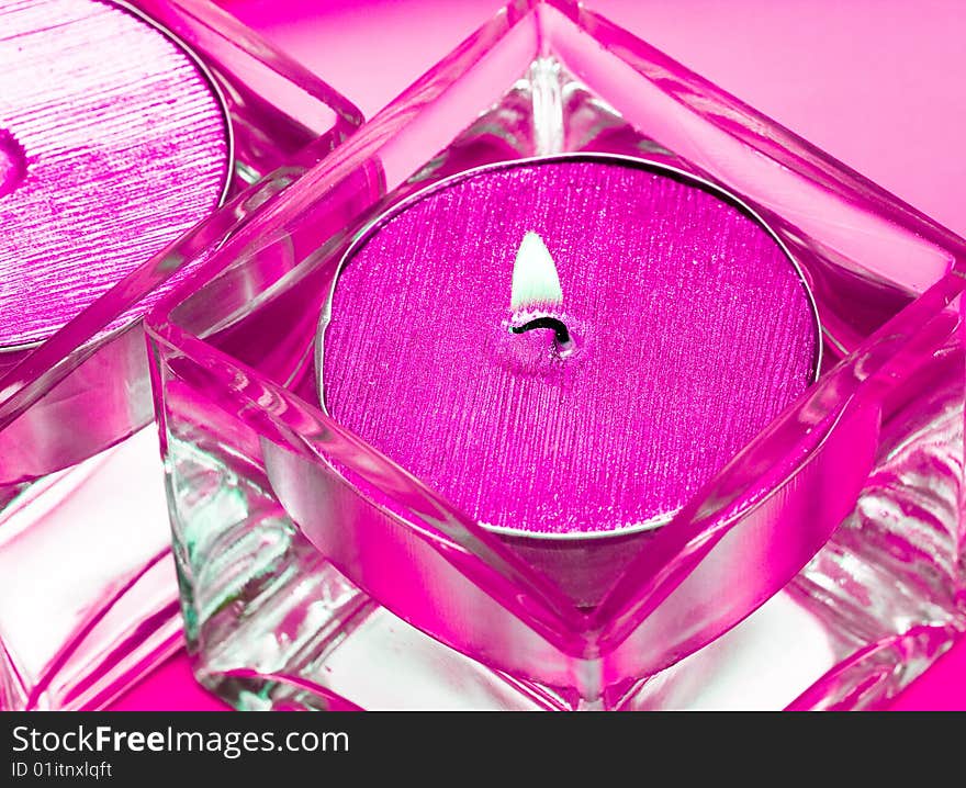 Pink candles in glass