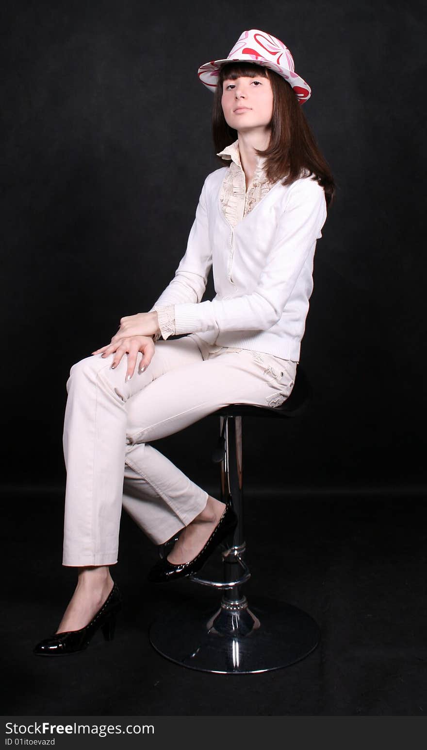 Smiling Girl Sitting On A Chair