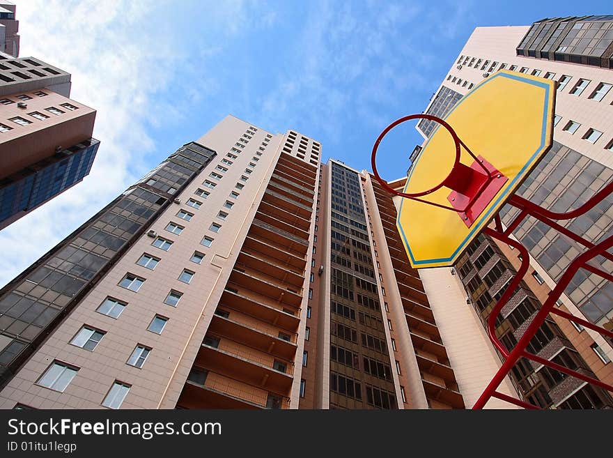 Children's basketball board with ring against high-rise buildings. Children's basketball board with ring against high-rise buildings