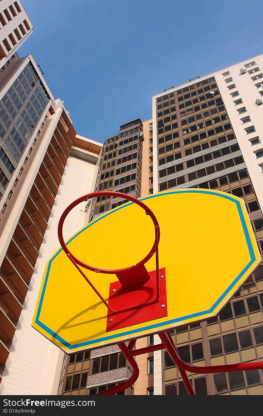 Children's basketball board with ring against high-rise buildings. Children's basketball board with ring against high-rise buildings