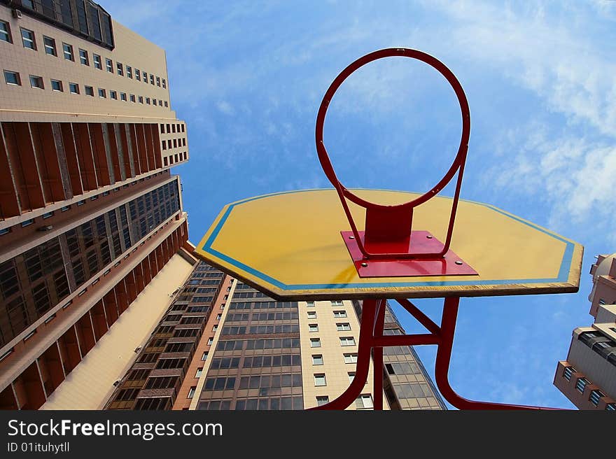 Children's basketball board with ring against high-rise buildings. Children's basketball board with ring against high-rise buildings