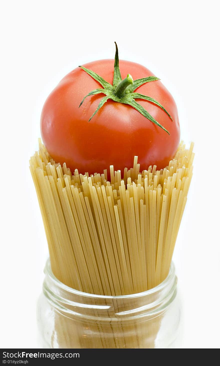 Spaghetti and mature tomato isolated on a white background