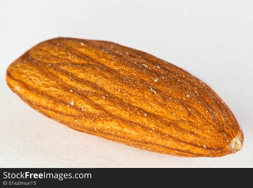 A macro shot of an almond nut against a white background