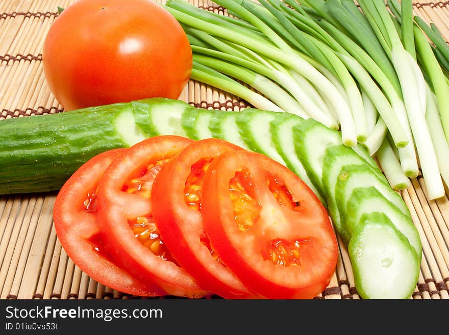 Fresh tomatoes, cucumbers and onions on a kitchen device. Fresh tomatoes, cucumbers and onions on a kitchen device