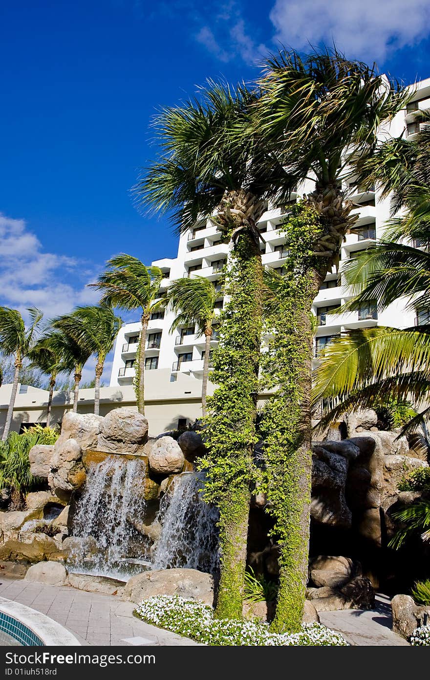 Palm trees and fountains around a luxury hotel property. Palm trees and fountains around a luxury hotel property