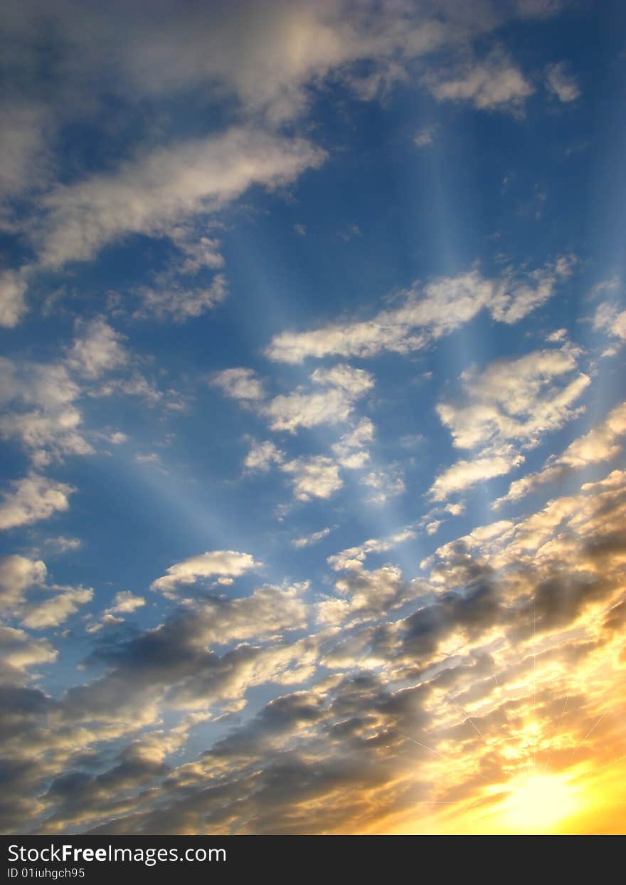 Bright sunset on  background of clouds with solar beams