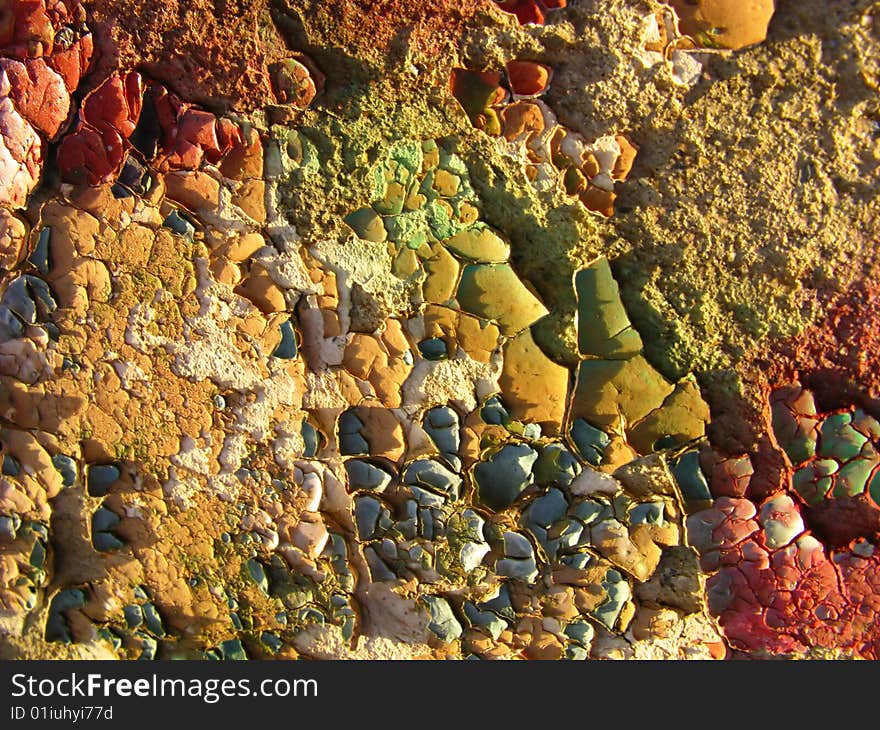 Paint and stones, old wall from various building materials. Paint and stones, old wall from various building materials