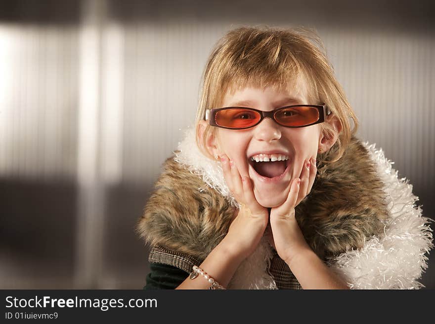 Cute young girl in dress-up clothes and red sunglasses. Cute young girl in dress-up clothes and red sunglasses