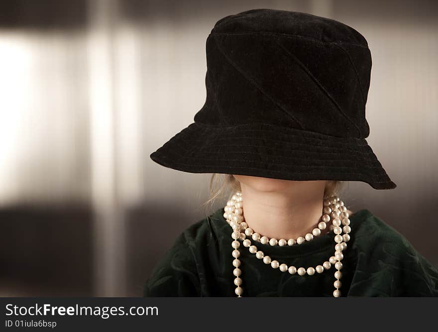 Girl with her face in her hat