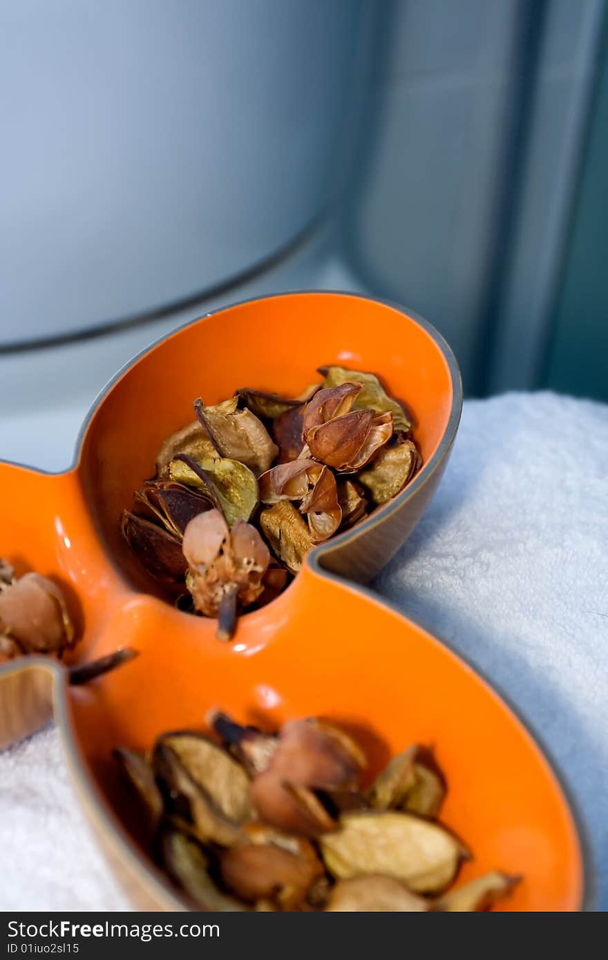 Dried aromatic in a unique orange bowl in the bathroom - home decor. Dried aromatic in a unique orange bowl in the bathroom - home decor