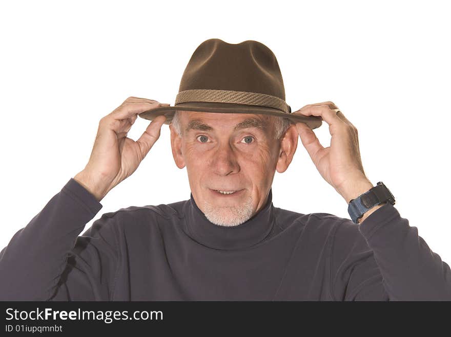 Senior man adjusting his hat ready to go out