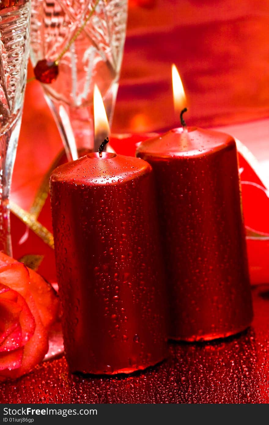 Celebration table, rose, candles and glasses with champagne