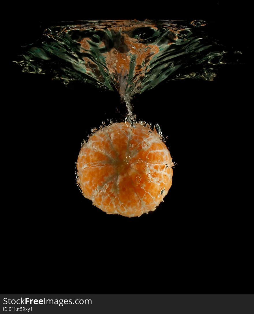 Orange in water on a black background