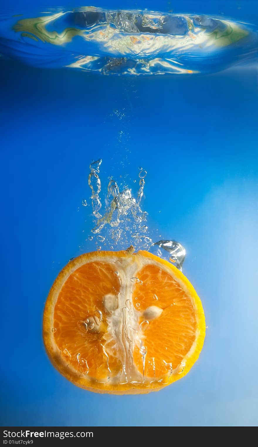 Orange in water on a blue background