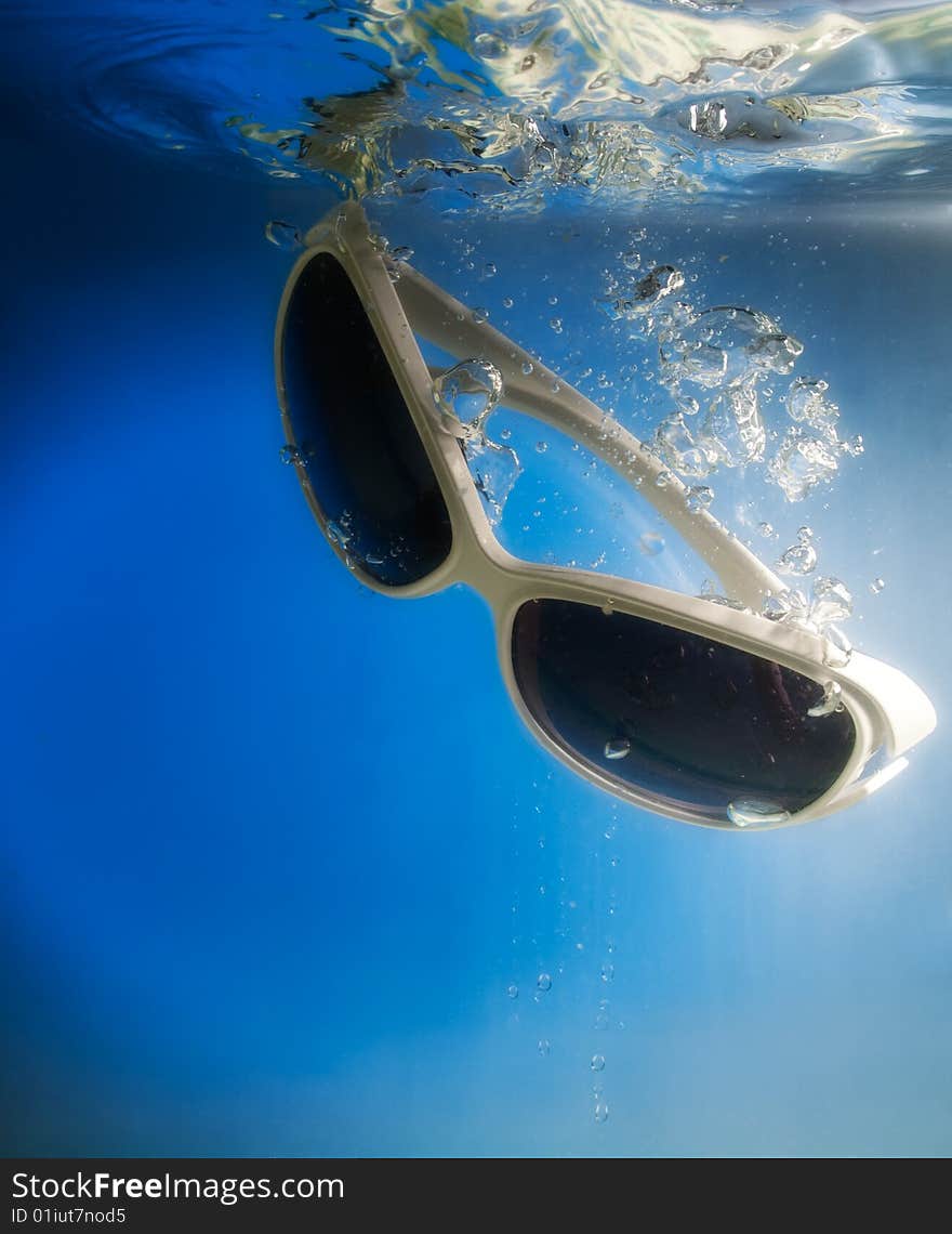 Glasses in water on a blue background