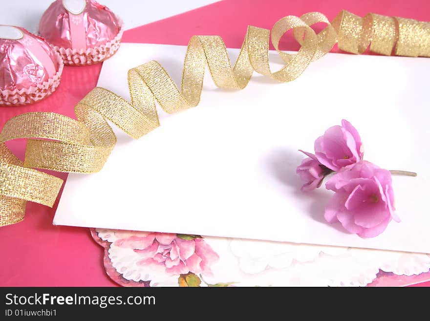 Background with a gold tape and flowers of pink color.