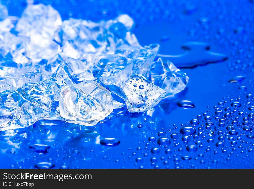 Close-up of ice cubes on blue