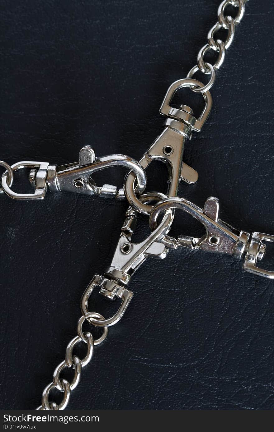 Close-up of steel locked chains on dark background