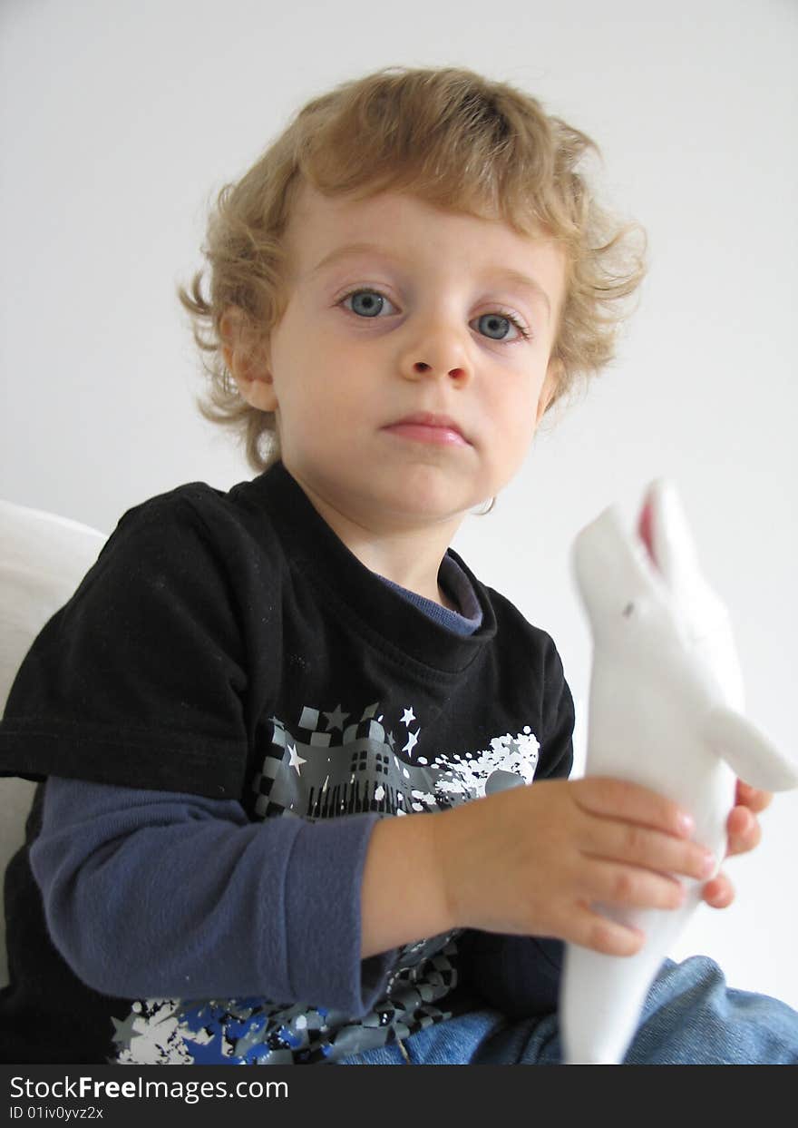 A young boy with a whale toy