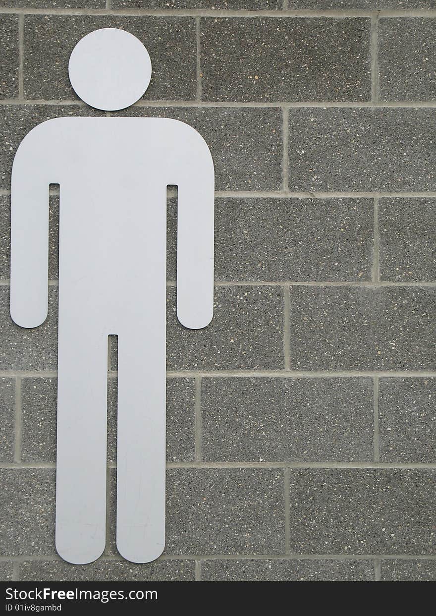 Male washroom sign on a wall. Male washroom sign on a wall