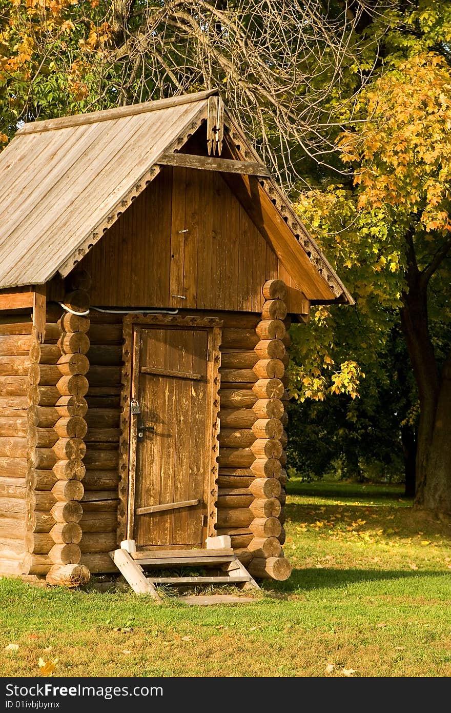 A small log house in an autumn park