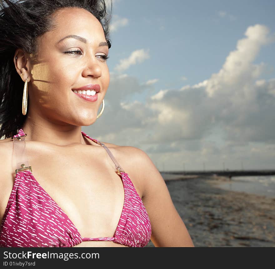 Young woman on the beach smiling