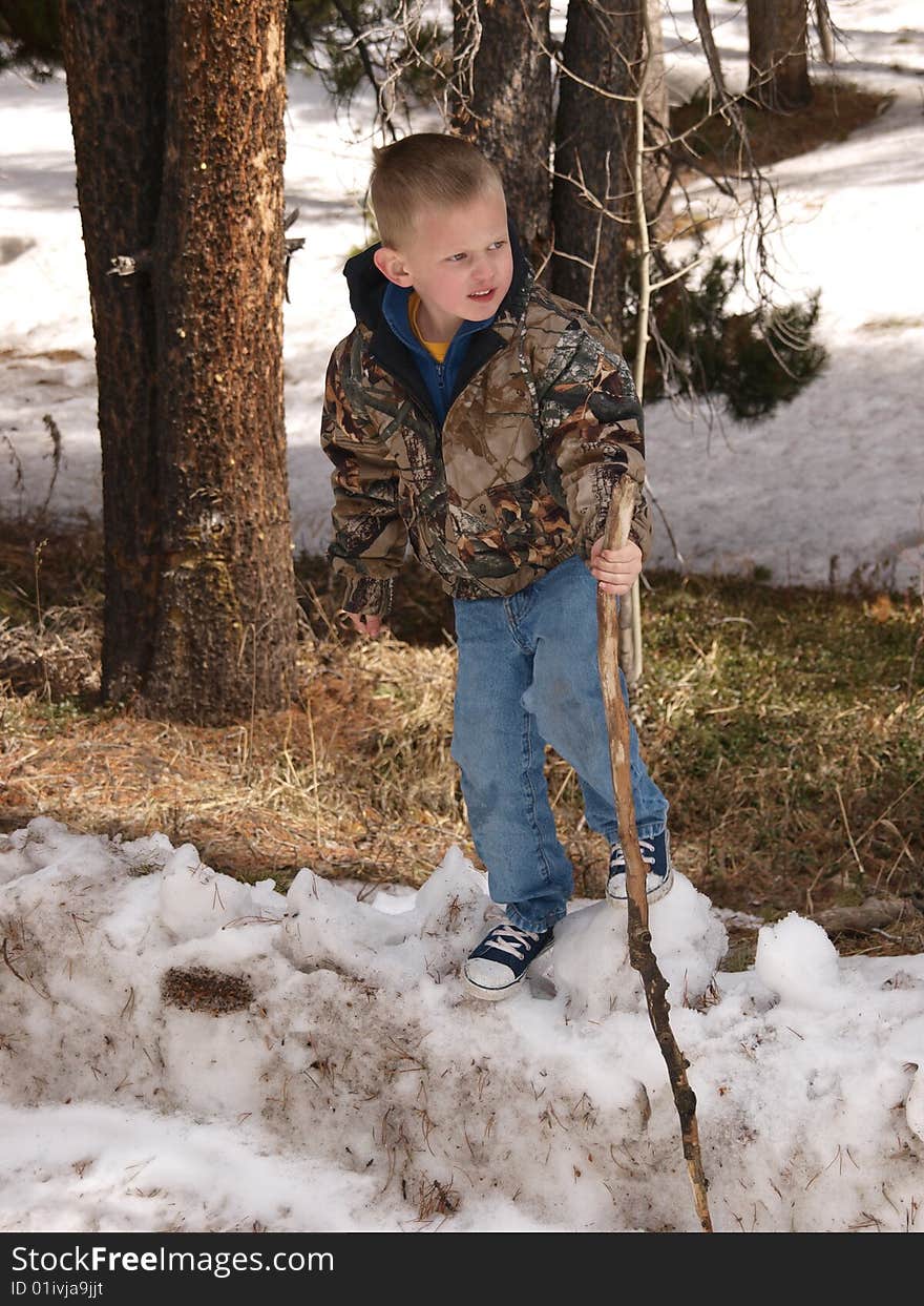 A color image of a young boy standing on a snow bank. A color image of a young boy standing on a snow bank.