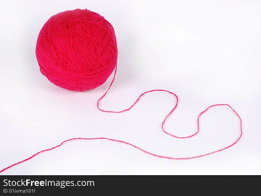 Red threads and clew  isolated on a white background. Red threads and clew  isolated on a white background