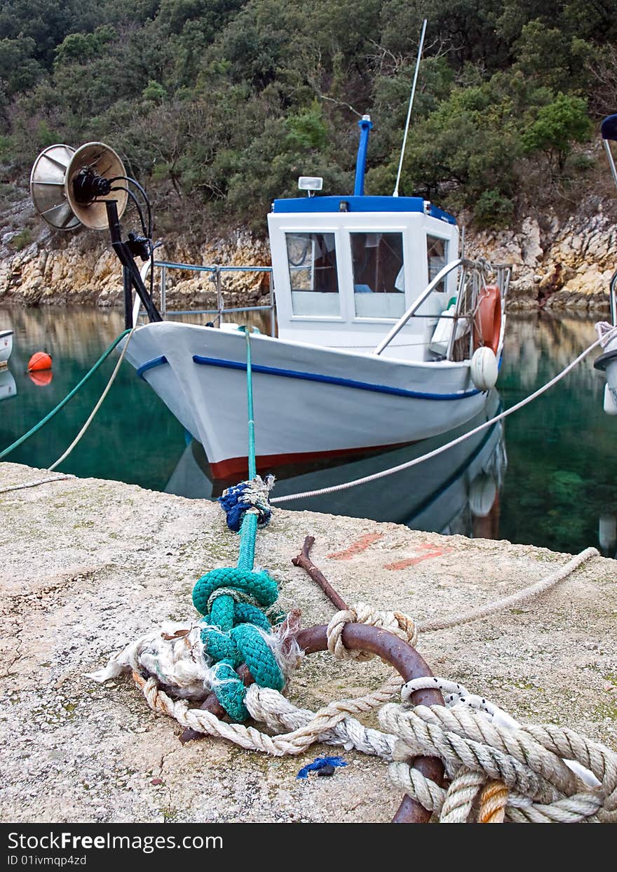 Old fishing boat in a small fishing port.