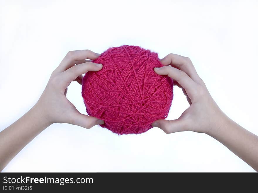 Red threads clew in hands isolated on a white background