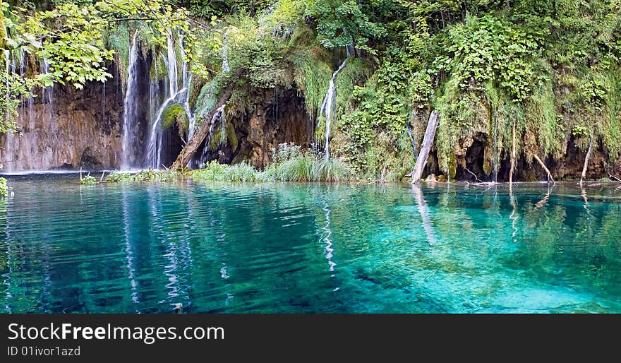 Beautiful waterfall and lake with blue water