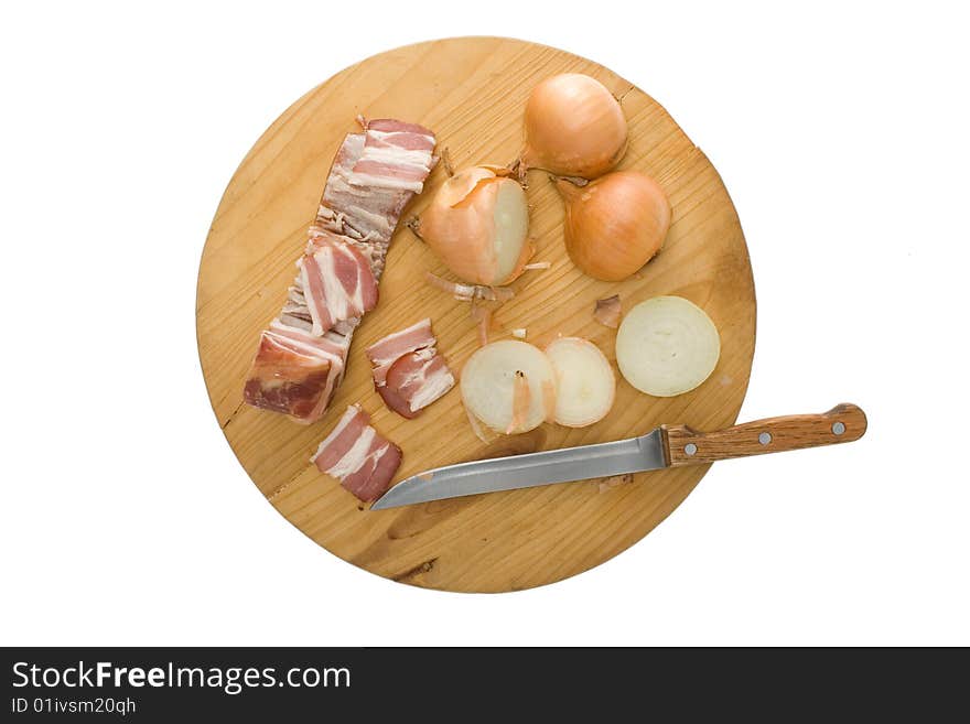 Bacon, onion and knife on kitchen  chopping board. Bacon, onion and knife on kitchen  chopping board