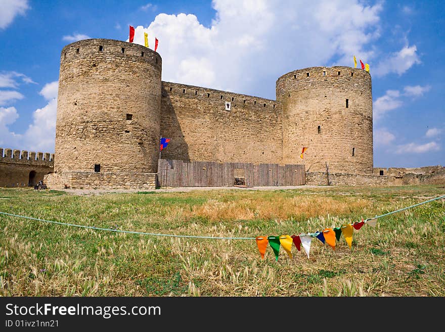 Old stone fortress with towers against blue sky. Old stone fortress with towers against blue sky