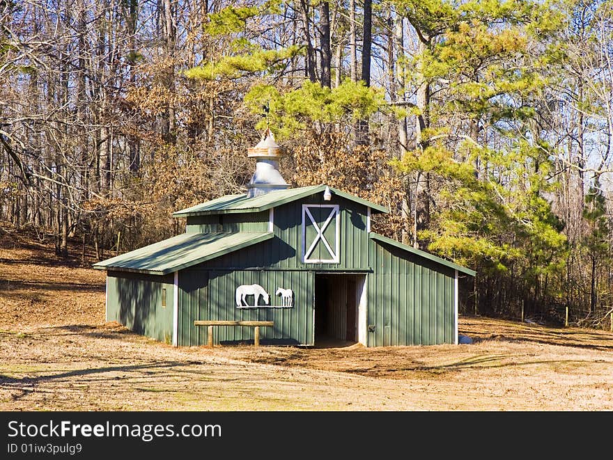 A green barn in a horse pasture. A green barn in a horse pasture