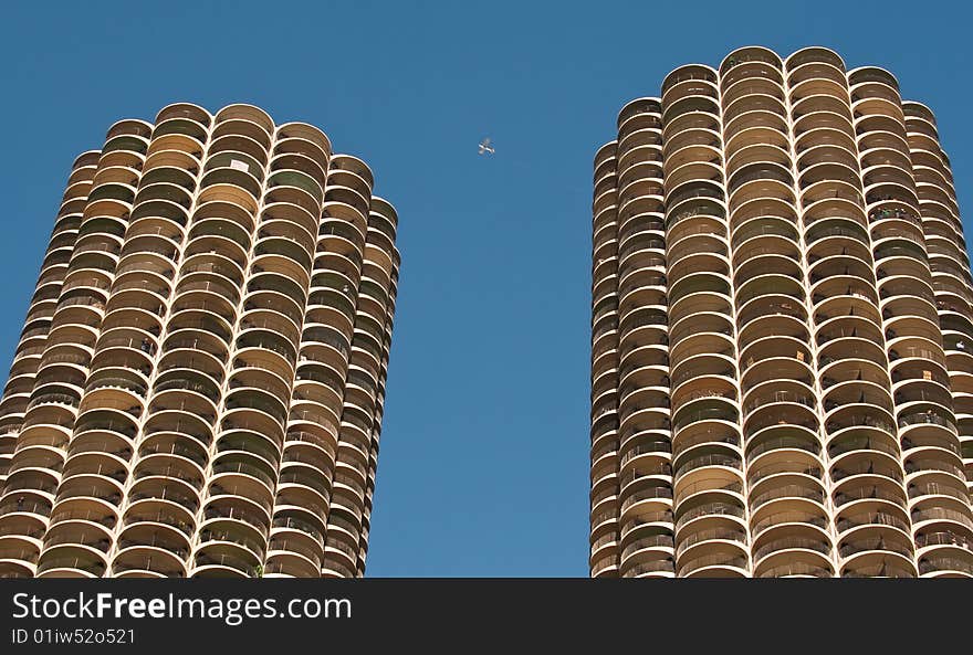 Plane flying between Marina City buildings in Chicago that look like corn cobs. Plane flying between Marina City buildings in Chicago that look like corn cobs