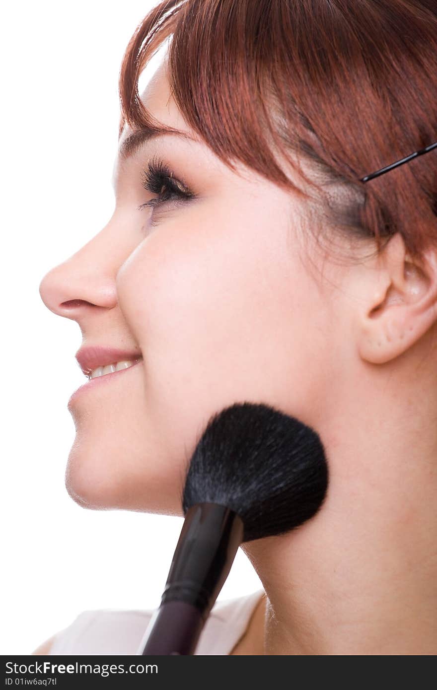 Attractive woman doing makeup. over white background